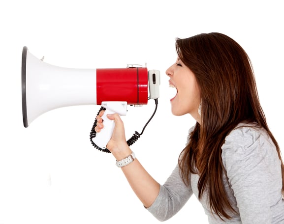 Woman screaming on a megaphone - isolated over white